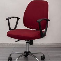 a red office chair sitting on top of a hard wood floor