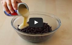 a person pouring something into a bowl filled with chocolate chips