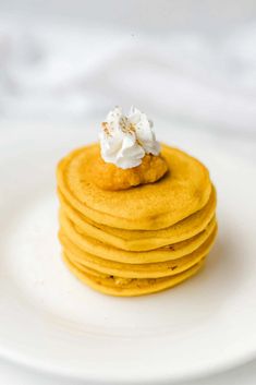 a stack of pancakes with whipped cream on top