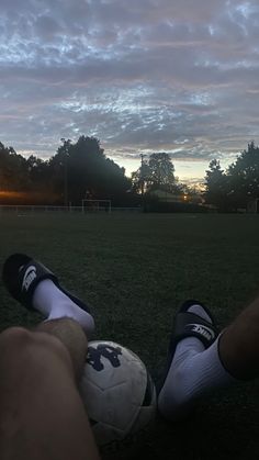 a person sitting on the ground with a soccer ball