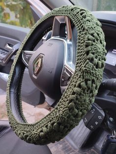 the steering wheel cover is crocheted with green yarn