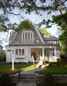 a large white house sitting on top of a lush green field