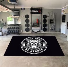 a gym with an area rug that says work hard at it's best