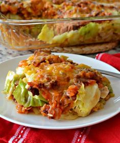 a casserole dish with meat and vegetables on a plate next to the casserole dish