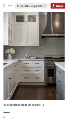 a kitchen with white cabinets and stainless steel range hoods over the stove top oven