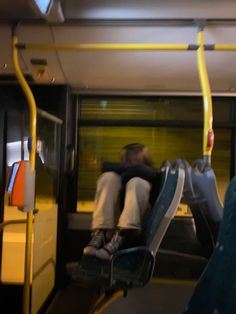 a person sitting on a bus with their head down