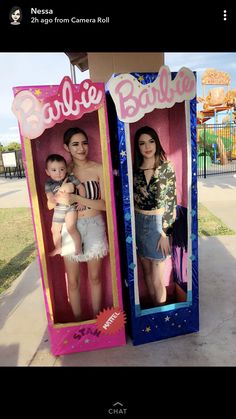 two cardboard barbie dolls are standing next to each other in the same box and one is holding a baby