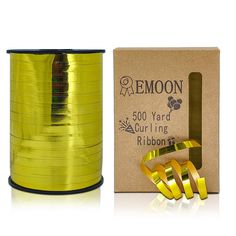 a spool of yellow ribbon next to a box