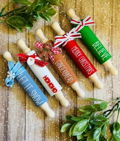 three christmas candles are sitting on a wooden table