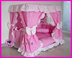 a pink bed with white polka dots on it