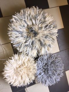 three pieces of fur sitting on top of a checkered floor