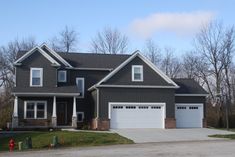 a large house with two car garages in front of it