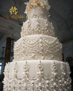 a large white wedding cake with flowers on top