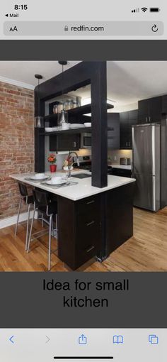 an image of a kitchen with black cabinets and white counter tops on the phone screen