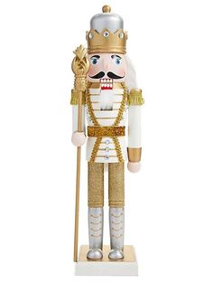 a nutcracker is standing on a white surface