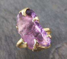 Amethyst Gold Ring Purple Gemstone Recycled 18k Gold Gemstone One of a kind Birthstone Unique Cocktail Statement ring byAngeline I hand carved the ring setting in wax then cast this treasure in recycled solid 18k gold in my home studio. I created a very organic rustic look for the setting. This ring is a size 6 1/2 it can be resized up or down. This amethyst gemstone is about 17mm X 9mm. This ring is rustic and handmade with love. Through out all of time and history in every tribe and culture al Yellow Gold Jewelry With Kunzite Gemstones, Handmade Amethyst Ring In Yellow Gold, Amethyst Gemstones In Yellow Gold With Prong Setting, Amethyst Gemstones In Prong Setting - Yellow Gold, Gold Amethyst Ring With Large Stone As Gift, Yellow Gold Amethyst Jewelry With Prong Setting, Yellow Gold Kunzite Jewelry Gift, Yellow Gold Amethyst Ring Gift, Yellow Gold Kunzite Jewelry As A Gift