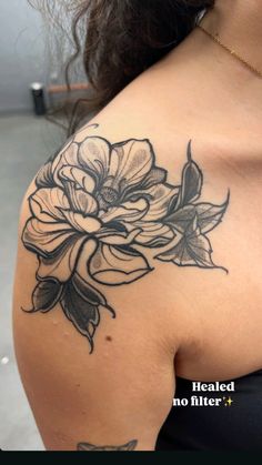 a woman's shoulder with flowers on it and the words healed no filter