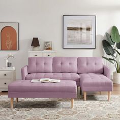 a living room with a purple couch and ottoman