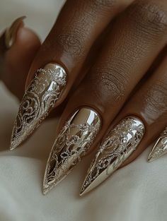 Elevate your nail style with this luxurious gold metallic nail art featuring a stunning lace pattern. This intricate and sophisticated design is perfect for making a statement, whether you're attending a special event or just want to add a touch of elegance to your look.   #NailInspiration #GoldNailArt #LuxuryNails #ElegantNails #NailTrends #NailDesign #FashionNails #ChicNails #StylishNails #ManicureIdeas #TrendyNails #NailArtLovers #StatementNails Pearl White And Gold Nails, Lux Nails Design, Intricate Nail Designs Nailart, 2025 Winter Nail Trends, Bohomoon Nails, New Years Nail Art 2024, Luxury Nails 2024, Gold Details Nails, New Years Party Nails