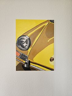 a yellow car with a skull painted on it's front grill is mounted to the wall