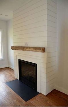 the fireplace is painted white and has a black mat in front of it that says save