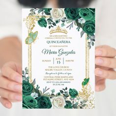 a woman holding up a green and white wedding card with gold trimmings on it