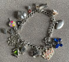 Cute Girly Sterling Silver Charm Bracelet with 15 Charms.  Some charms are enameled. Some have stones.  I believe all are Sterling Silver as well as the bracelet itself.  The telephone handset lifts off the base.  Very cute and unique.  Please email me for International shipping Costs         It comes from a non-smoking home   I ship on Tuesdays and Thursdays Thank you for looking! Silver Charm Bracelet In Costume Jewelry Style, Silver Costume Jewelry Charm Bracelet, Silver Enamel Charm Bracelets, Silver Charm Bracelets With Enamel, Silver Enamel Bracelets With Charms, Silver Enamel Jewelry With Dangling Charms, Silver Enamel Charm Bracelet, Silver Enamel Jewelry With Vintage Charm, Beautiful Rings Vintage