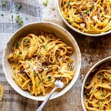 three bowls filled with pasta on top of a table