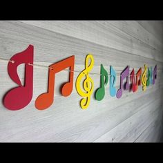 colorful musical notes are hanging on the wall