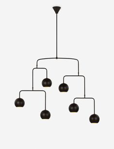 a chandelier with five black balls hanging from it's center, and four dark brown ones on each end