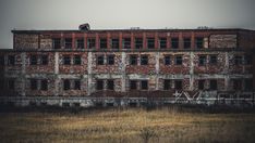 an old building with windows and graffiti on it