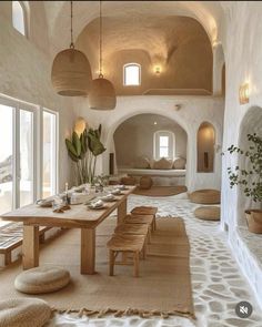 an indoor dining area with tables, chairs and potted plants in the middle of the room