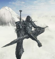 an alien like creature standing on top of a snow covered mountain with his arms in the air