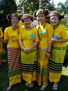 four girls in yellow dresses are posing for the camera