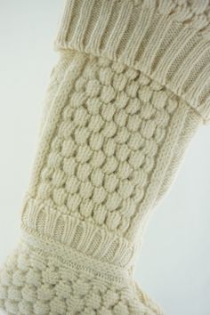 a pair of white knitted socks on top of each other