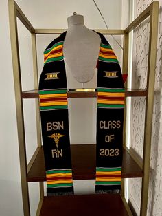 a scarf with the words bsn class of 202 printed on it sitting on a shelf