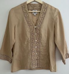 Women's vintage Laura Ashley button up blouse in tan colour Linen Cotton embroidery around edges Size 8 or small in excellent vintage condition Beige Button-up Blouse With Floral Embroidery, Beige Embroidered Button-up Top, Vintage Beige Linen Blouse, Beige Linen Tops With Floral Embroidery, Embroidered Beige Linen Top, Beige Embroidered Linen Top, Linen Button-up Top With Embroidery, Linen Embroidered Button-up Top, Embroidered Linen Button-up Top