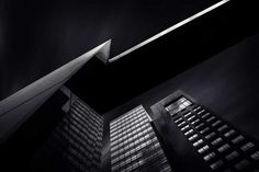 two tall buildings are shown in the dark