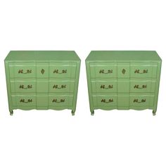 a pair of green dressers sitting next to each other