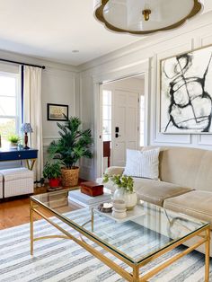 a living room filled with furniture and a glass coffee table