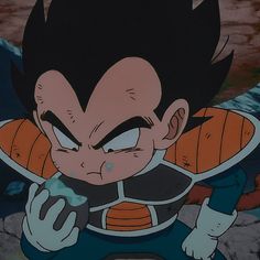 an animated image of gohan holding something in his hand