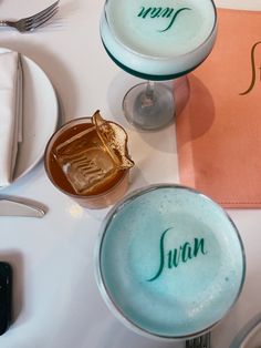 there are two desserts on the table with name plates and silverware next to each other