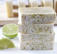 three lime bars stacked on top of each other next to sliced limes and a cutting board