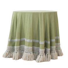 a green table cloth with tassels on the bottom and white trim around it