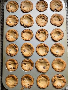 freshly baked chocolate chip cookies on a cookie sheet ready to go in the freezer