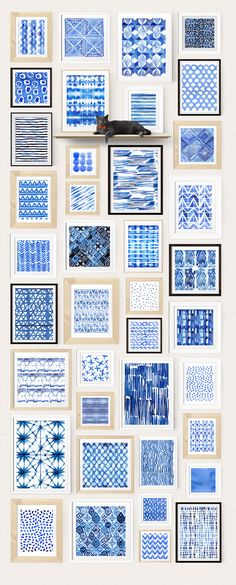 blue and white watercolors are displayed on the wall