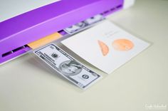 a purple case with money sticking out of it