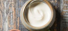 a jar of yogurt sitting on top of a wooden table