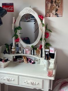 a white vanity with pink flowers on it and a mirror above the dresser, next to a coca cola sign