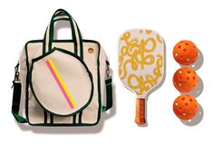 an orange tennis racquet, bag and three balls